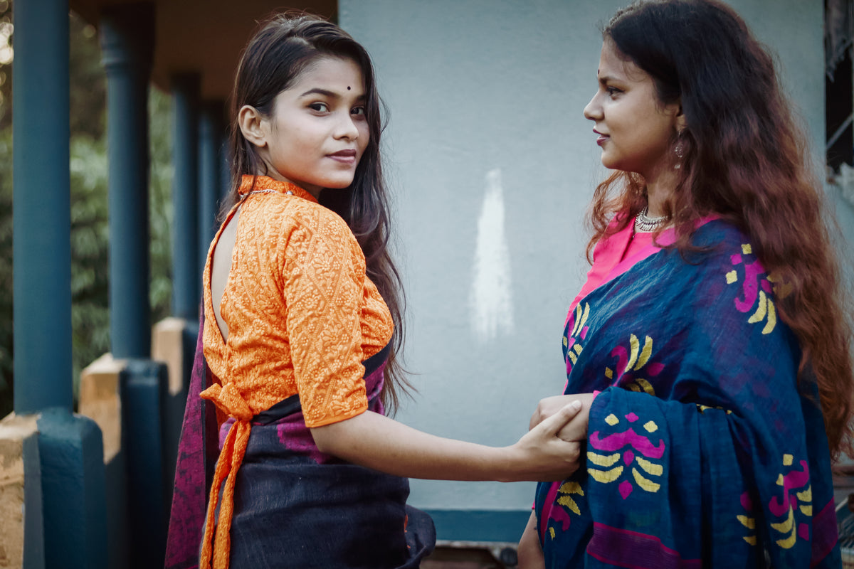 Two women in colorful traditional outfits